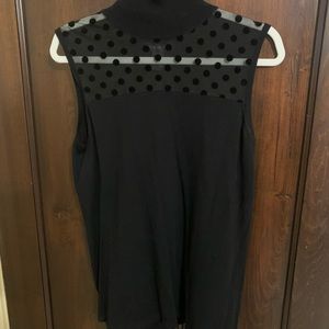 Black sleeveless top.  Sheer on top with cute polka dots.